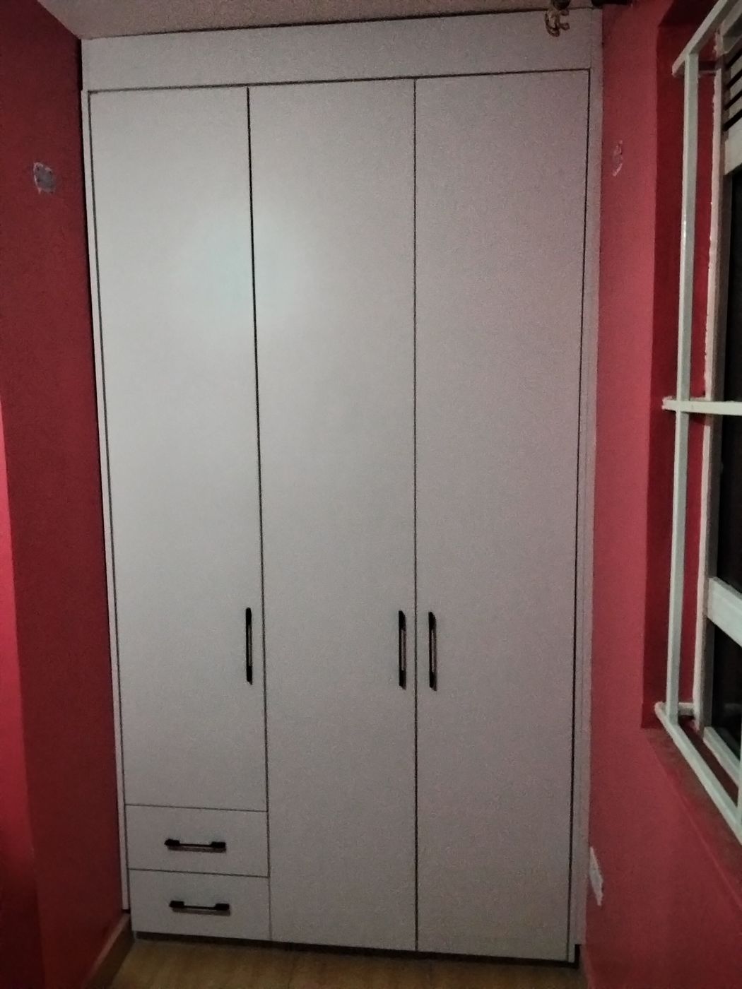 Floor-to-ceiling white built-in wardrobe with drawers, made by Procut
