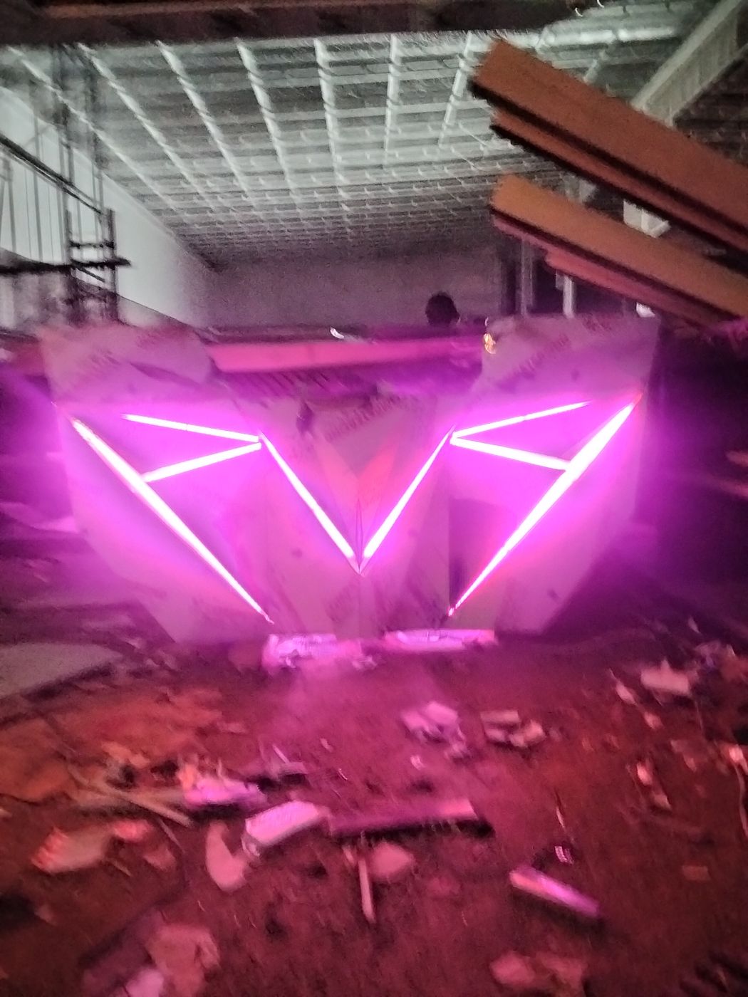 Club bar counter with geometric panels and neon lighting