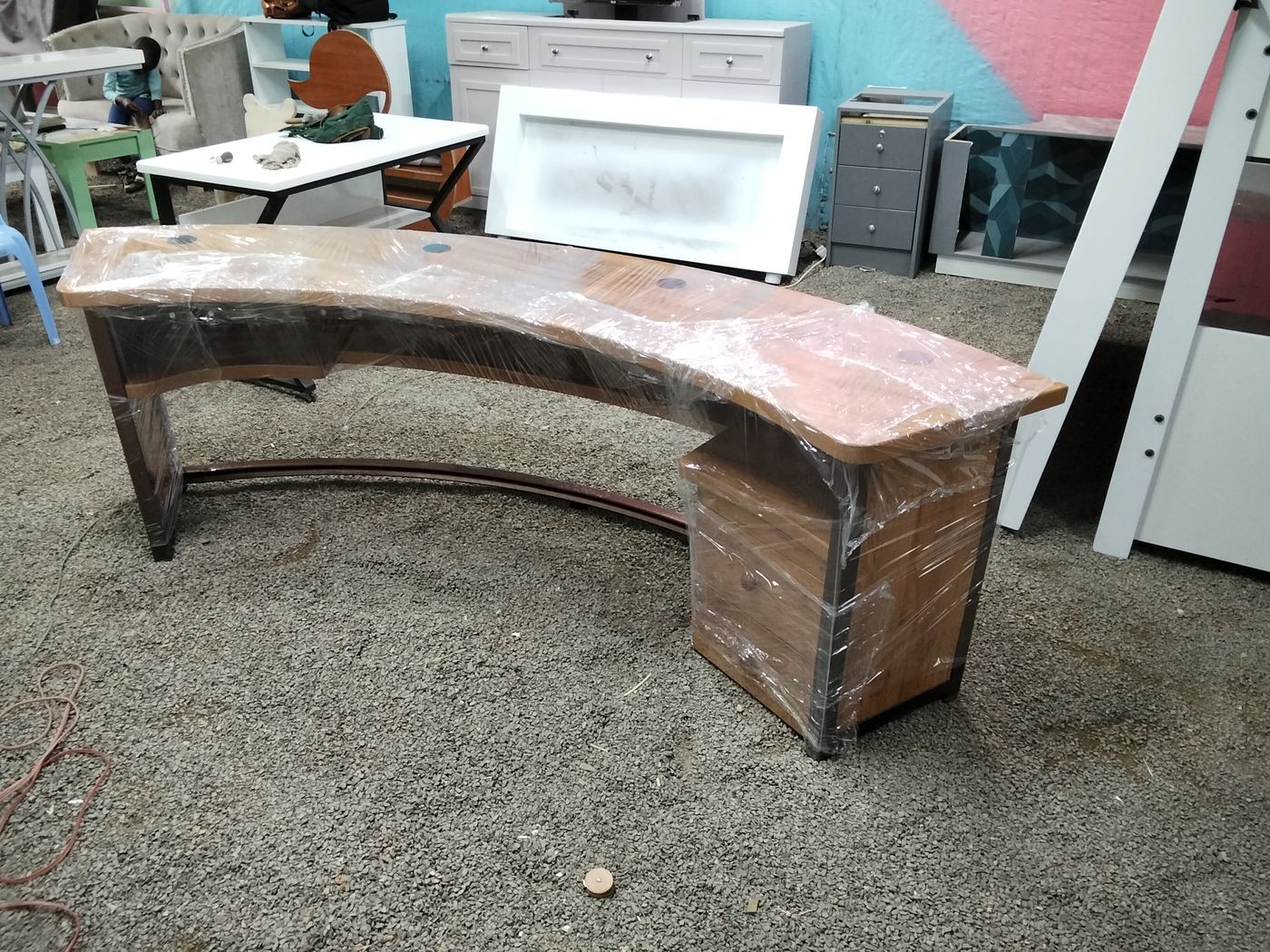 Curved reception desk in wood-grain finish being built by Procut