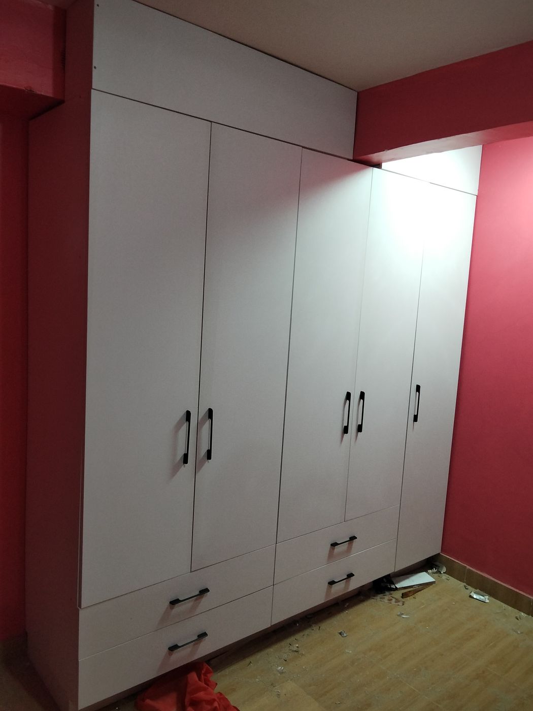 White fitted wardrobe with black handles and drawers
