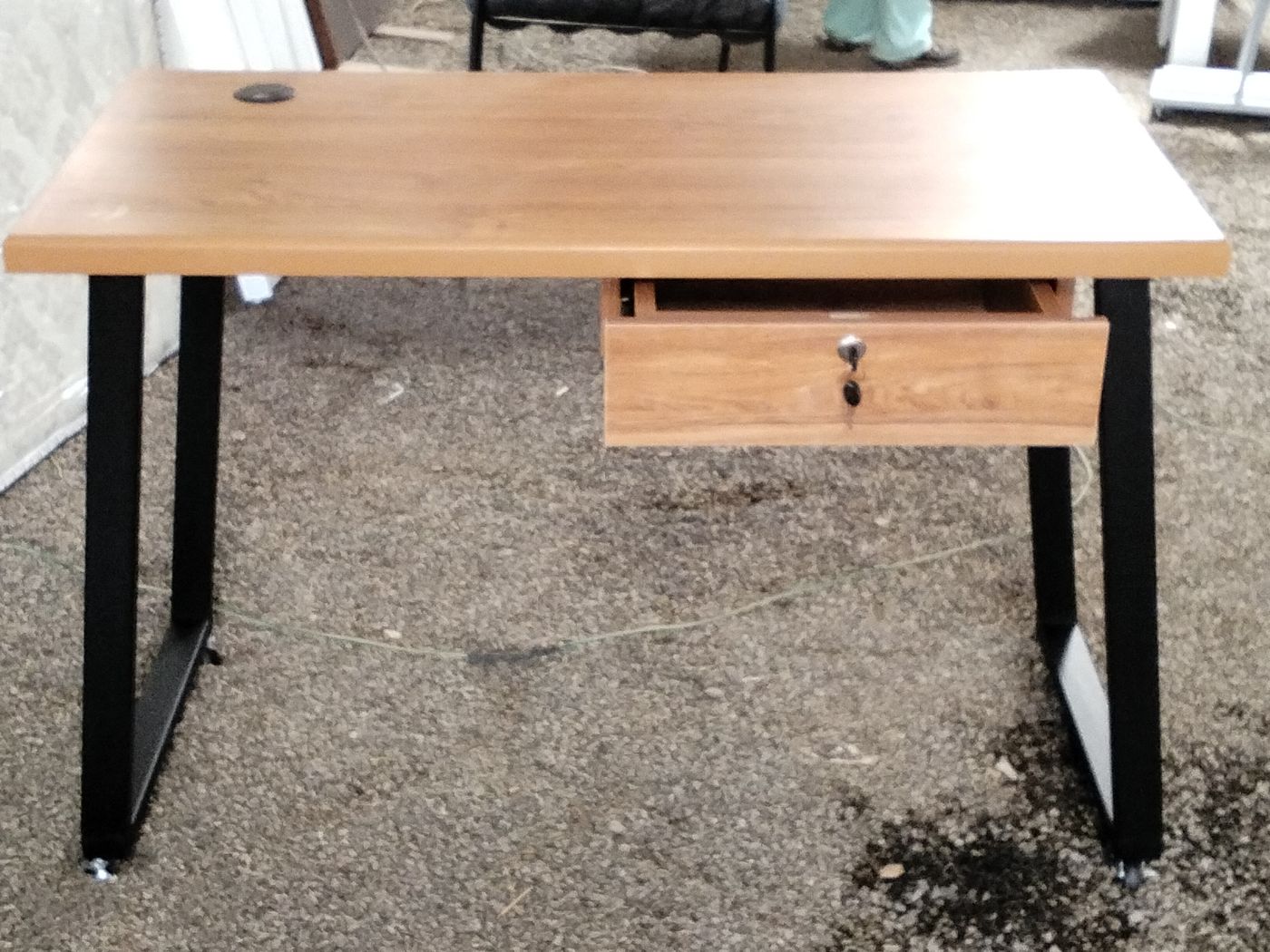Office desk with wood-grain top, drawer and black steel frame